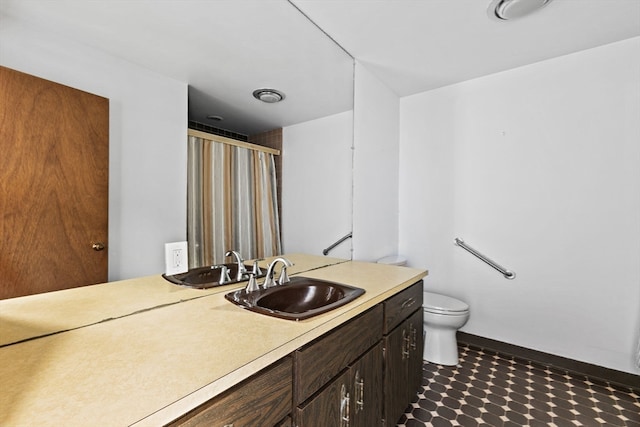 bathroom with vanity, an enclosed shower, and toilet