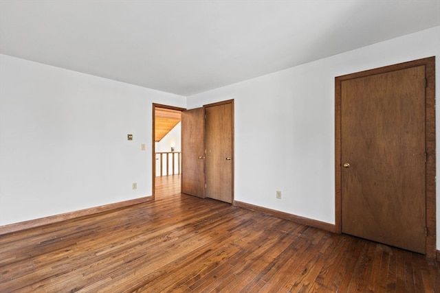 unfurnished bedroom featuring dark hardwood / wood-style flooring