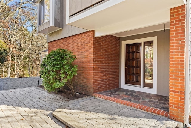 entrance to property featuring a patio area