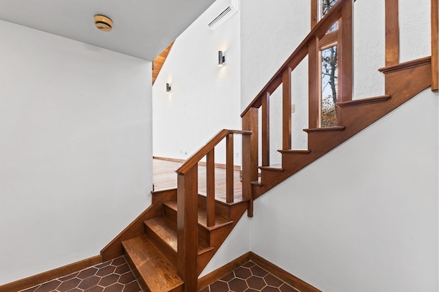 staircase with tile patterned floors