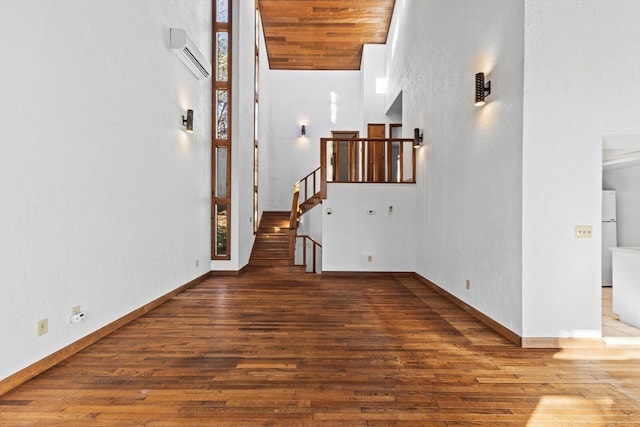 hallway with a wall mounted AC and dark wood-type flooring