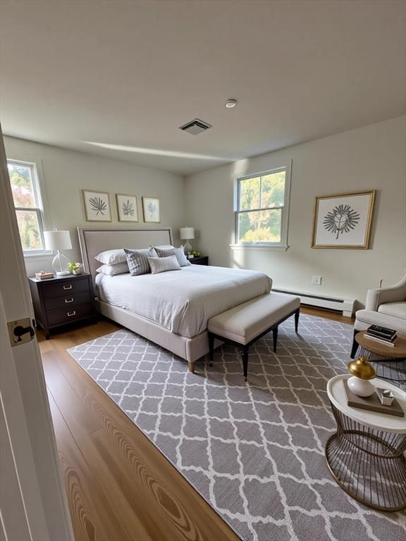 21 Friends Ln, Dennis, MA 02660 - bedroom featuring a baseboard radiator and wood finished floors