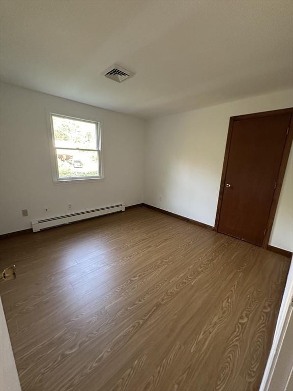21 Friends Ln, Dennis, MA 02660 - spare room featuring baseboard heating and dark wood-style flooring