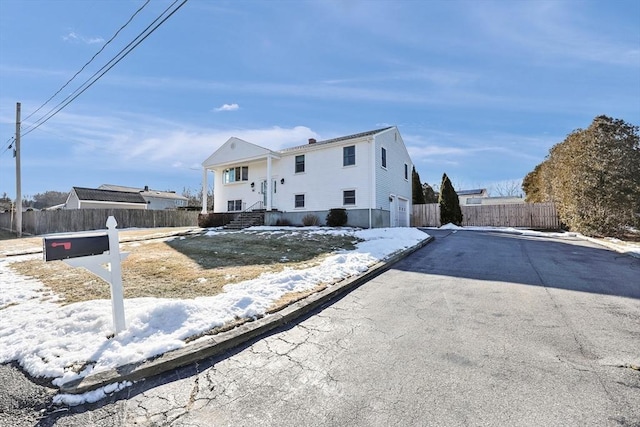 view of front of house with driveway and fence