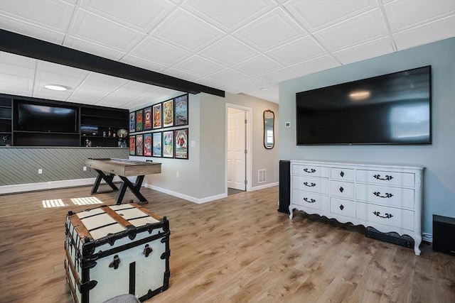 recreation room with visible vents, baseboards, and wood finished floors