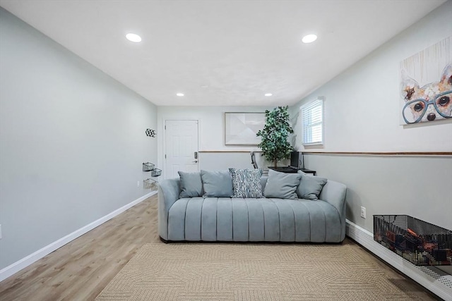 living room with light wood finished floors, baseboards, and recessed lighting