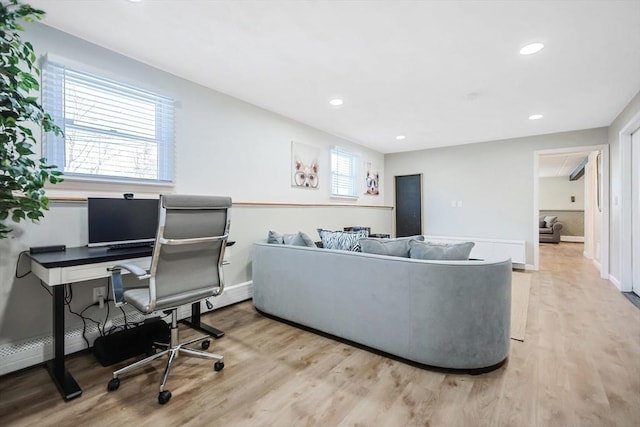 living room with light wood finished floors, baseboards, and recessed lighting