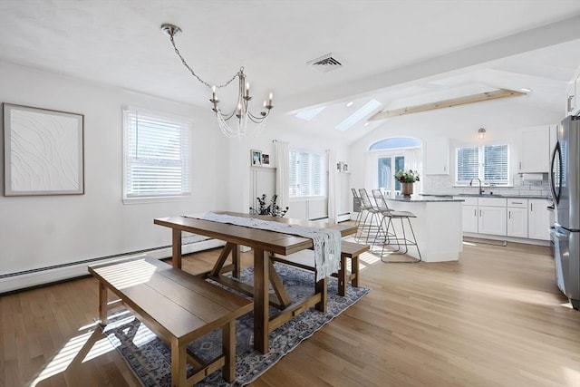 dining area with vaulted ceiling with beams, light wood-style floors, visible vents, and a notable chandelier