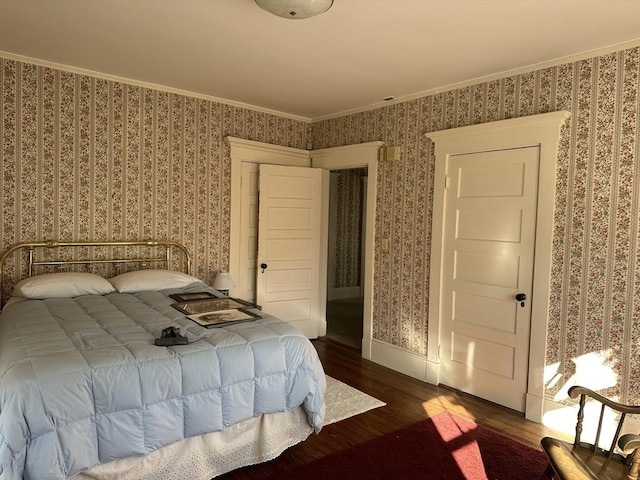 bedroom with crown molding and dark hardwood / wood-style floors