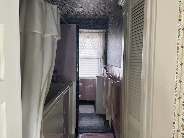 laundry area featuring tile walls