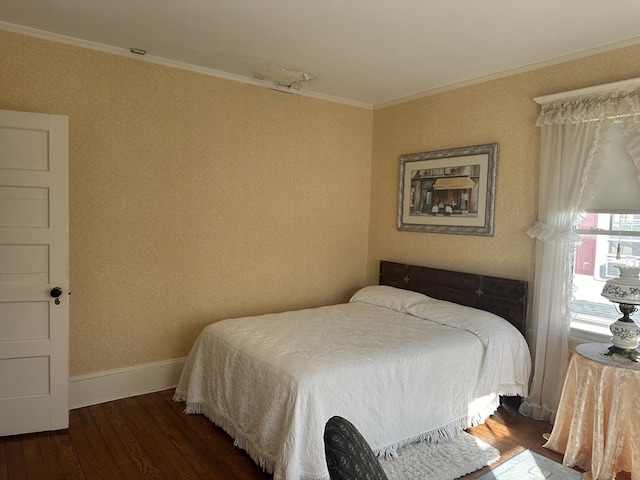 bedroom featuring crown molding and dark hardwood / wood-style floors