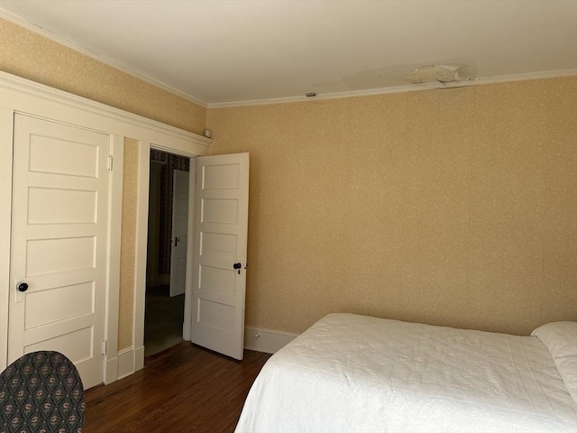 bedroom with crown molding and dark hardwood / wood-style floors