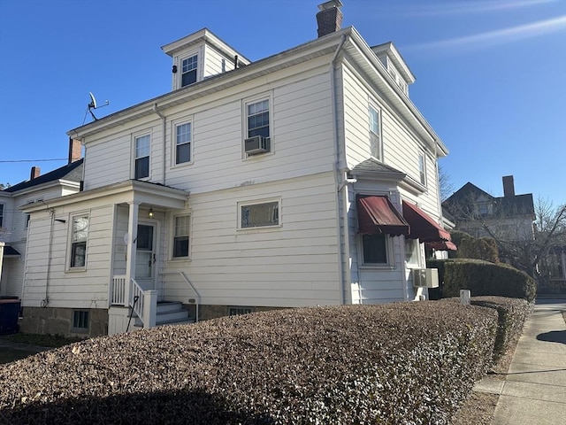 rear view of house featuring cooling unit