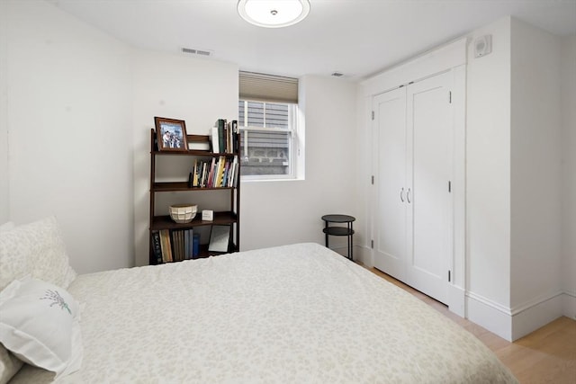 bedroom with a closet and light wood-type flooring