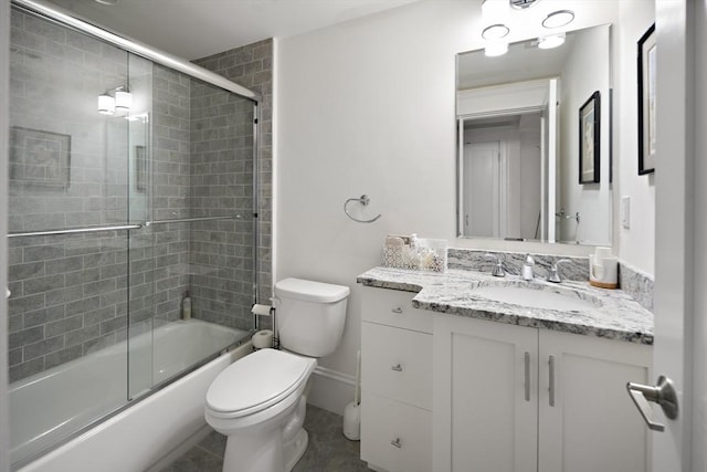 full bathroom with vanity, combined bath / shower with glass door, and toilet