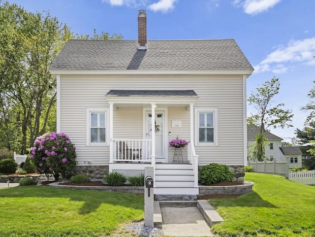 5 Adams St, Littleton, MA 01460 - view of front facade with covered porch, a chimney, and roof with shingles