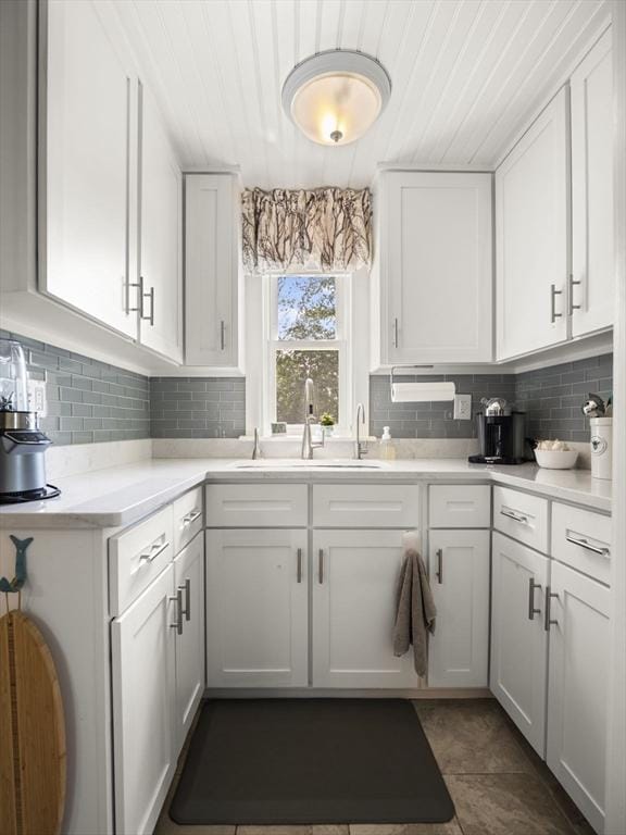 5 Adams St, Littleton, MA 01460 - kitchen with a sink, decorative backsplash, white cabinetry, light countertops, and wooden ceiling
