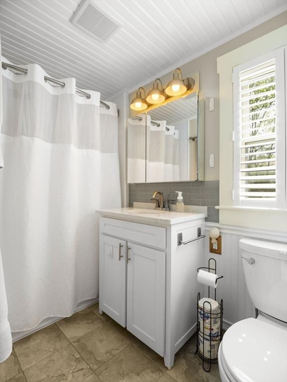 5 Adams St, Littleton, MA 01460 - bathroom featuring vanity, toilet, backsplash, and curtained shower