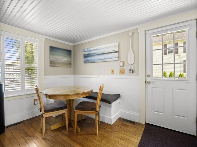 5 Adams St, Littleton, MA 01460 - dining space with hardwood / wood-style floors, a wainscoted wall, crown molding, and baseboards