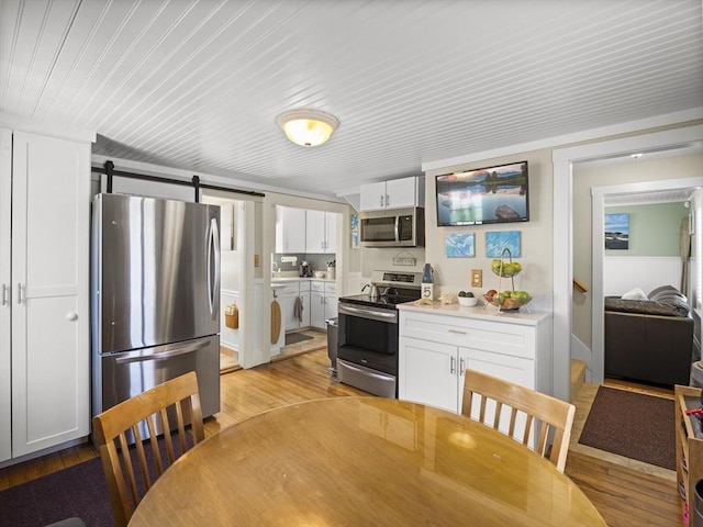 5 Adams St, Littleton, MA 01460 - kitchen featuring appliances with stainless steel finishes, light wood-style flooring, and white cabinetry