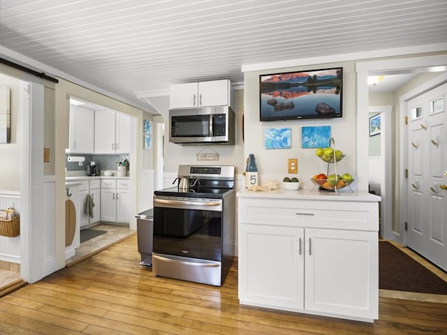 5 Adams St, Littleton, MA 01460 - kitchen with appliances with stainless steel finishes, light wood-style floors, white cabinets, and light countertops