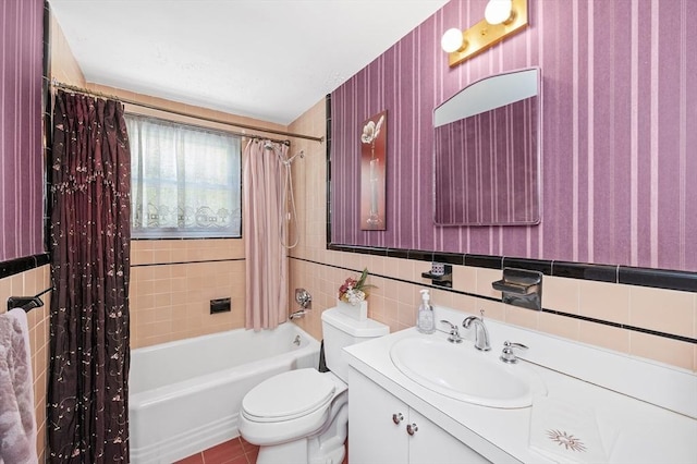 full bath with shower / bath combo with shower curtain, toilet, tile walls, and vanity