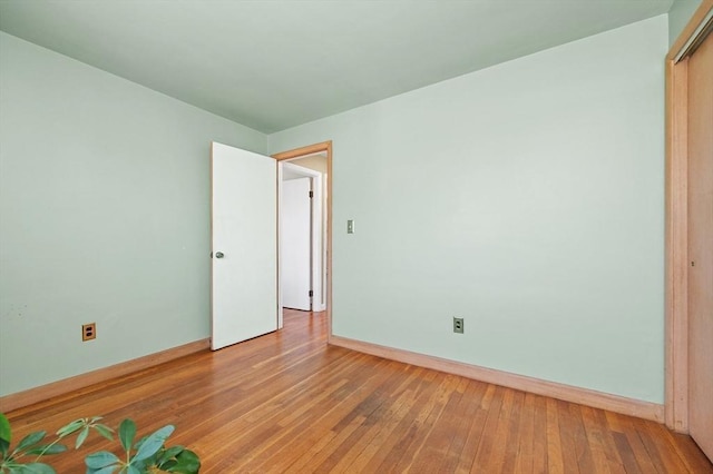 interior space featuring baseboards and hardwood / wood-style flooring