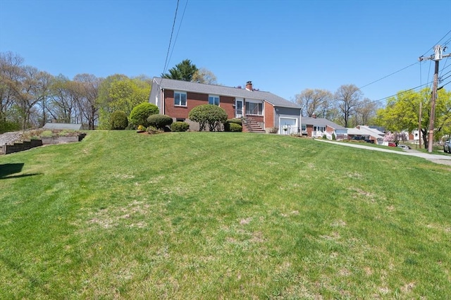 view of front of house with a front lawn and a chimney