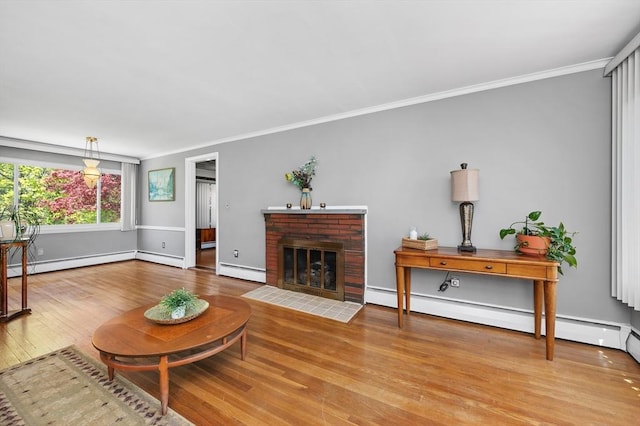 living room featuring crown molding, a baseboard radiator, baseboard heating, and wood finished floors