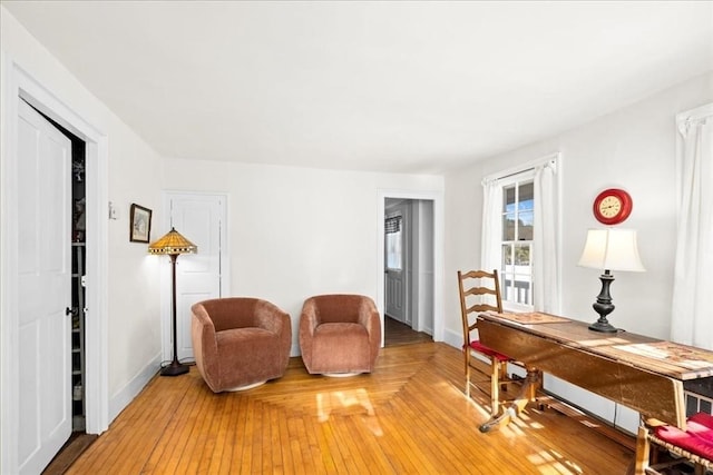 living area with baseboards and light wood finished floors