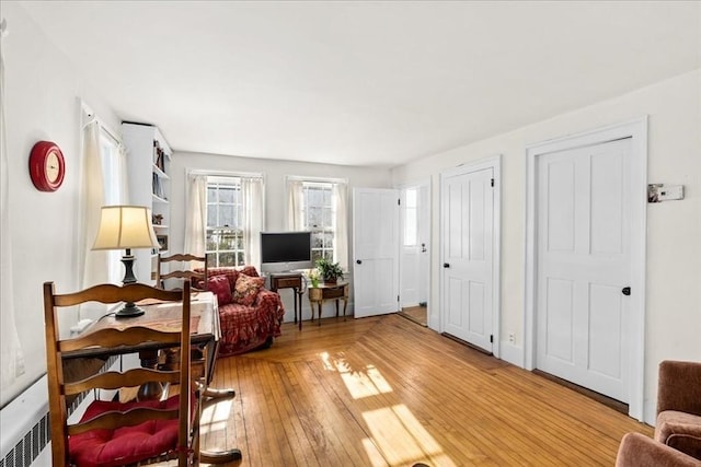 living area featuring radiator heating unit and light wood finished floors