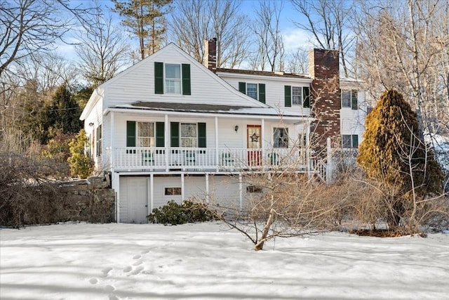 view of front facade with a porch and a chimney