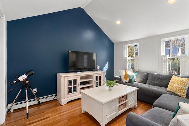 living room featuring light wood-style flooring, vaulted ceiling, baseboard heating, and recessed lighting