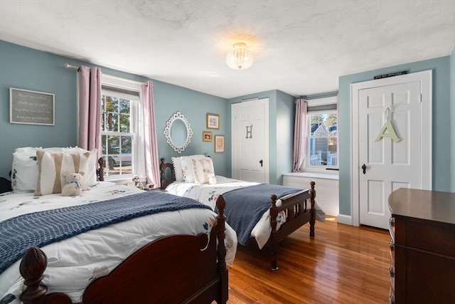 bedroom with baseboards and wood finished floors