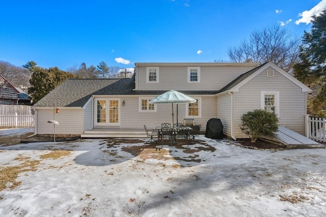 back of house featuring french doors, roof with shingles, fence, and a wooden deck