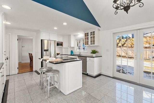 kitchen with dark countertops, granite finish floor, appliances with stainless steel finishes, and recessed lighting