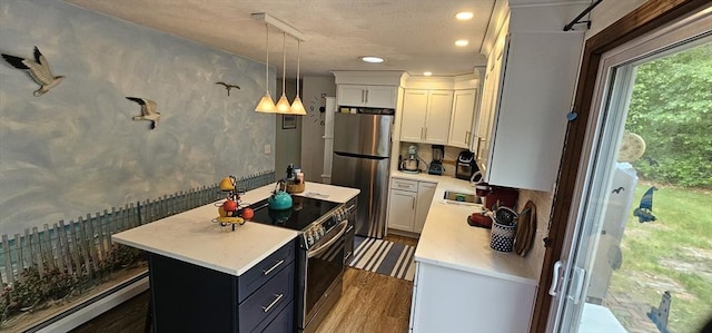 3 Kenneth St, Sandwich, MA 02537 - kitchen with appliances with stainless steel finishes, a kitchen island, light countertops, recessed lighting, and wood finished floors