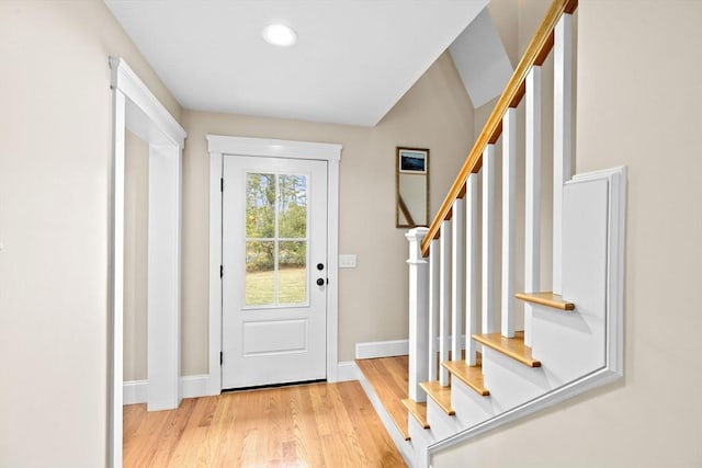 doorway to outside featuring stairs, wood finished floors, and baseboards