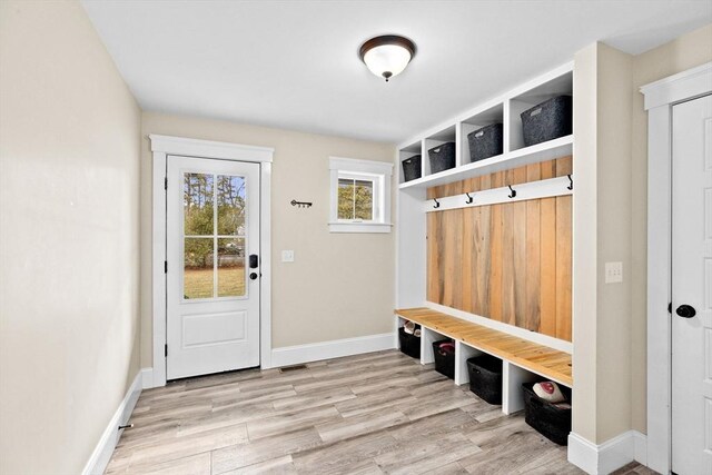 mudroom with baseboards and wood finished floors