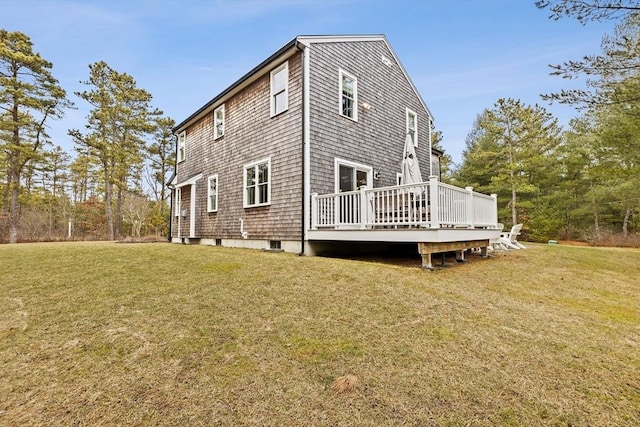 rear view of property featuring a yard and a wooden deck