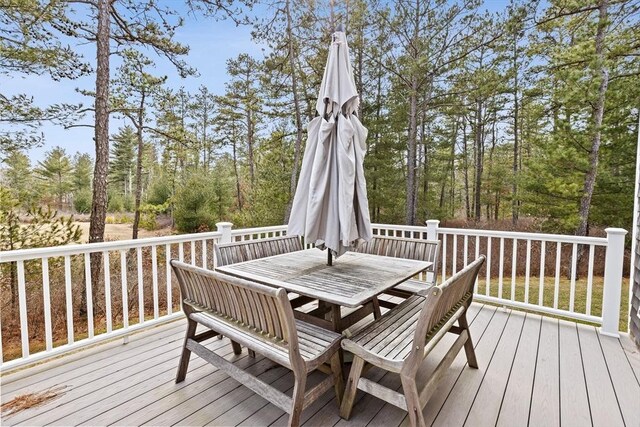 wooden terrace featuring outdoor dining area