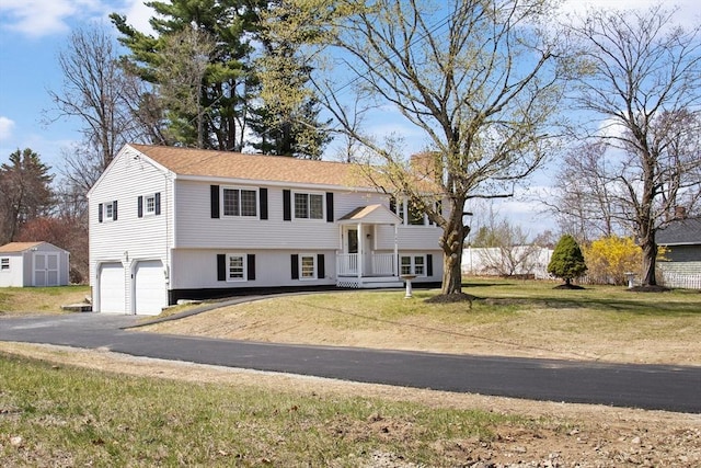 765 S Mammoth Rd, Manchester, NH 03109 - bi-level home with driveway, an outdoor structure, an attached garage, a front yard, and a storage shed