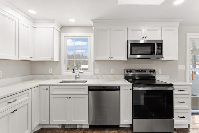 765 S Mammoth Rd, Manchester, NH 03109 - kitchen with a sink, white cabinetry, plenty of natural light, and appliances with stainless steel finishes