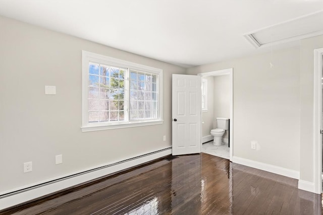 765 S Mammoth Rd, Manchester, NH 03109 - unfurnished bedroom featuring connected bathroom, attic access, dark wood-type flooring, baseboards, and a baseboard heating unit