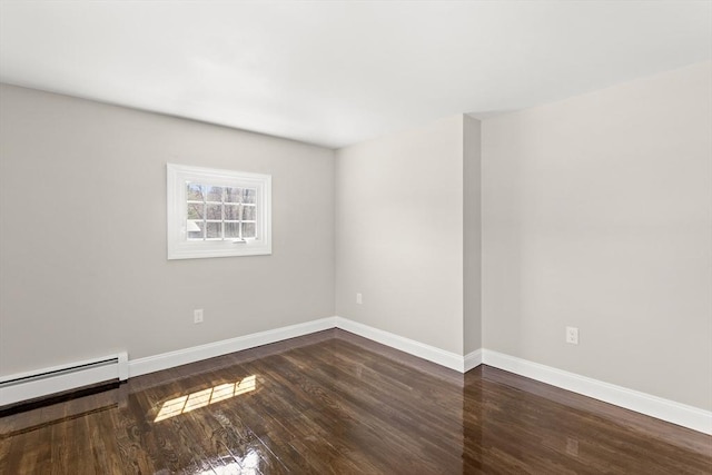 765 S Mammoth Rd, Manchester, NH 03109 - spare room featuring baseboards, wood finished floors, and a baseboard radiator