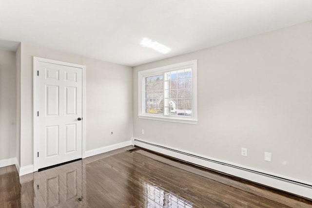 765 S Mammoth Rd, Manchester, NH 03109 - unfurnished bedroom featuring wood finished floors, baseboards, and a baseboard heating unit