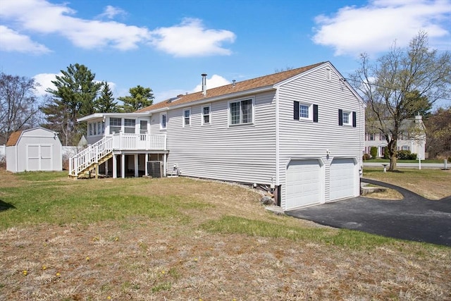 765 S Mammoth Rd, Manchester, NH 03109 - rear view of property featuring a storage shed, a garage, a sunroom, aphalt driveway, and stairs