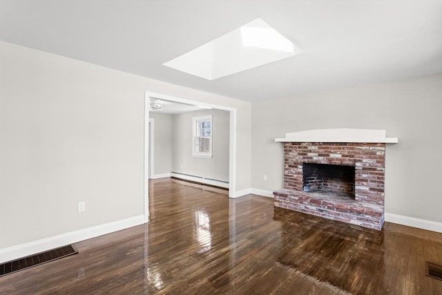 765 S Mammoth Rd, Manchester, NH 03109 - unfurnished living room with baseboards, hardwood / wood-style floors, baseboard heating, and visible vents