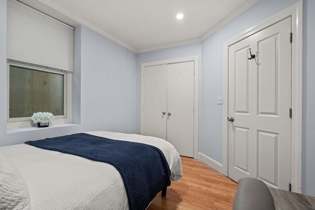 bedroom featuring crown molding, hardwood / wood-style flooring, and a closet