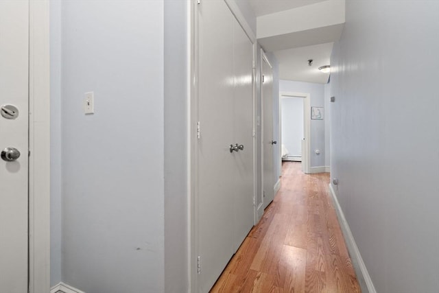 hallway with a baseboard radiator and light wood-type flooring